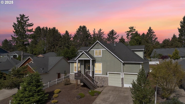 view of front of property featuring covered porch and a garage