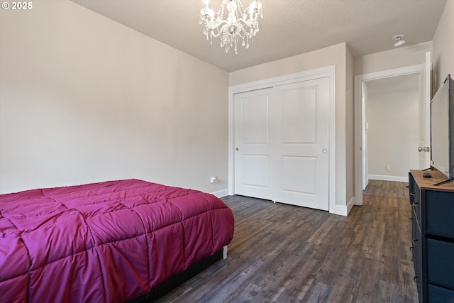 5779 NE Voyage Way, Lincoln City, OR 97367 - bedroom featuring dark wood-type flooring and a notable chandelier