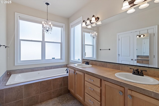 5779 NE Voyage Way, Lincoln City, OR 97367 - bathroom with a chandelier, vanity, a relaxing tiled tub, and a wealth of natural light