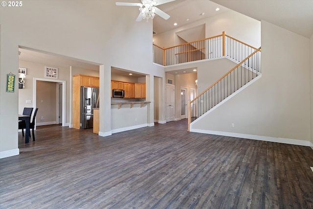 5779 NE Voyage Way, Lincoln City, OR 97367 - unfurnished living room with ceiling fan, dark hardwood / wood-style floors, and a high ceiling