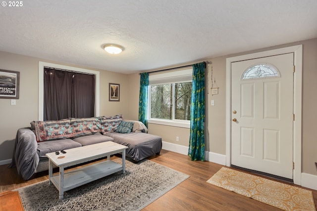 foyer featuring a textured ceiling and light hardwood / wood-style floors