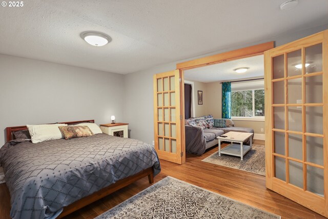 bedroom featuring wood-type flooring and a textured ceiling