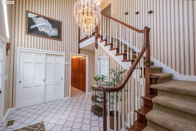 840 Springhill Dr, Albany, OR 97321 - tiled entryway featuring wallpapered walls, a chandelier, and stairs