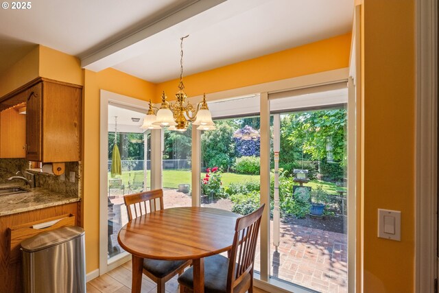 840 Springhill Dr, Albany, OR 97321 - dining area featuring a chandelier, beamed ceiling, and light wood-type flooring