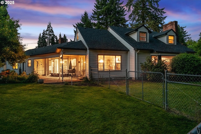 840 Springhill Dr, Albany, OR 97321 - back of house at dusk with a chimney, a shingled roof, and a gate