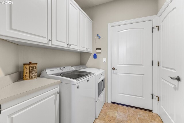 clothes washing area featuring cabinet space, stone finish floor, and washer and dryer