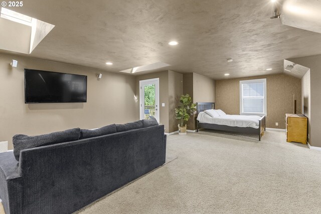 carpeted bedroom with access to outside, recessed lighting, a skylight, and baseboards