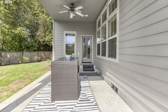 view of patio with fence and ceiling fan