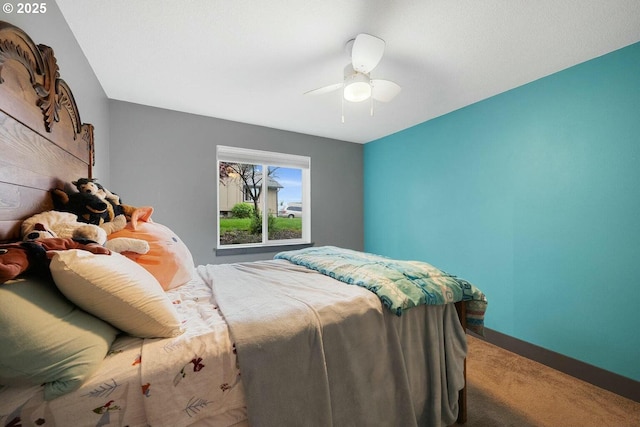 bedroom featuring ceiling fan and carpet