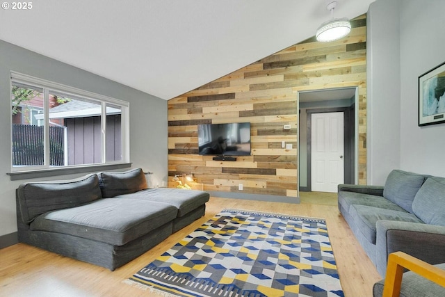 living room featuring wooden walls, vaulted ceiling, and hardwood / wood-style flooring