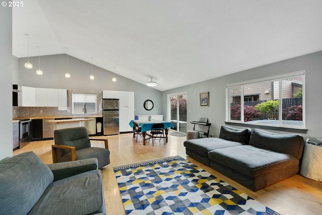 living room featuring light hardwood / wood-style flooring and lofted ceiling