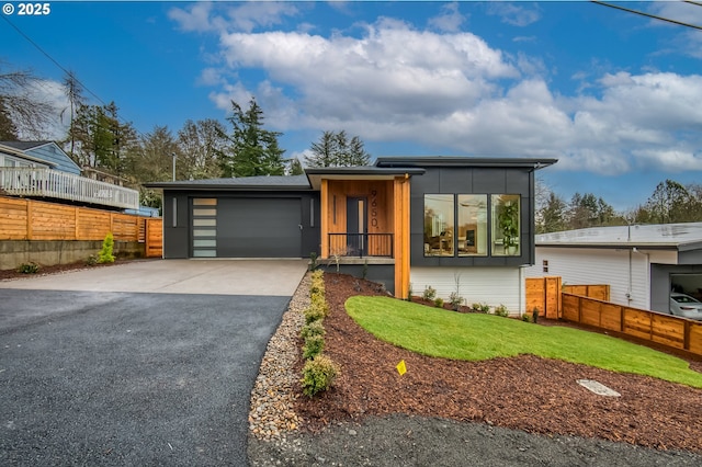 modern home featuring a front lawn and a garage