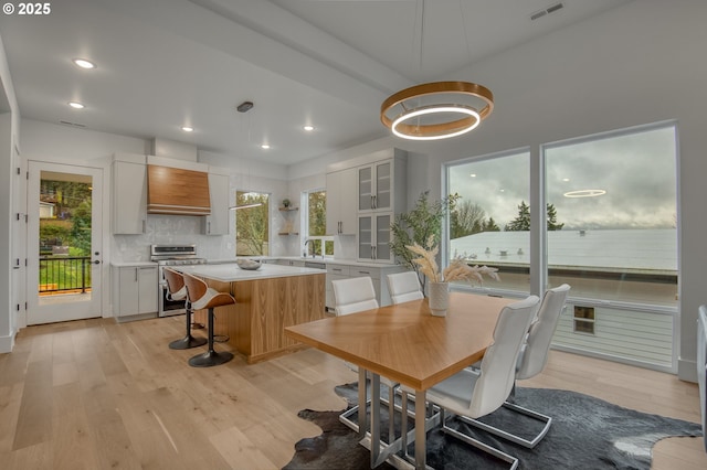 dining room with sink and light hardwood / wood-style flooring