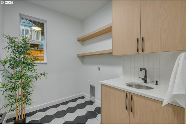 washroom featuring cabinets, washer hookup, electric dryer hookup, and sink