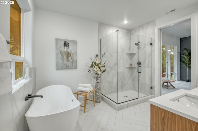 bathroom featuring vanity and shower with separate bathtub