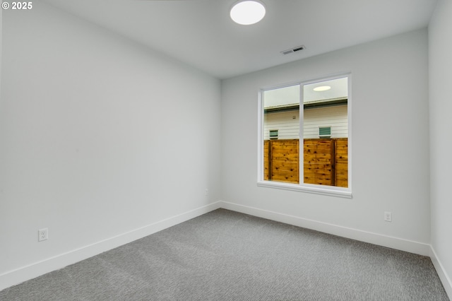 spare room featuring carpet floors