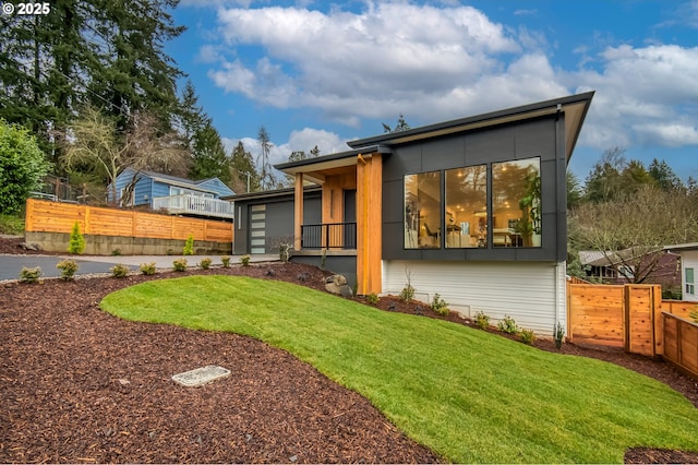 rear view of property featuring a yard