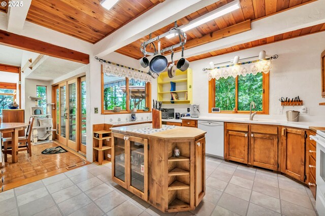 25498 Butler Rd, Junction City, OR 97448 - kitchen with white dishwasher, open shelves, a wood ceiling with exposed beams, plenty of natural light, and brown cabinets