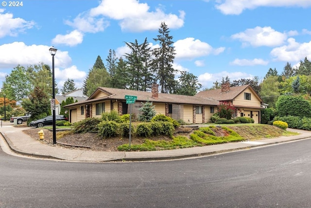 8050 SW 103rd Ave, Beaverton, OR 97008 - ranch-style home featuring a chimney and an attached garage