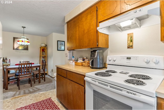 8050 SW 103rd Ave, Beaverton, OR 97008 - kitchen featuring white electric range oven, under cabinet range hood, brown cabinetry, light countertops, and a textured ceiling