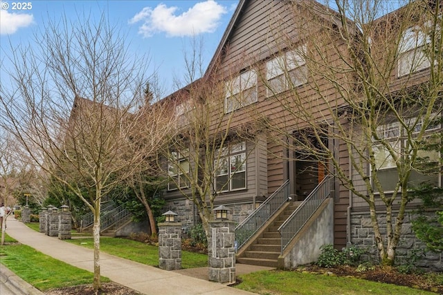 exterior space with stone siding and stairs