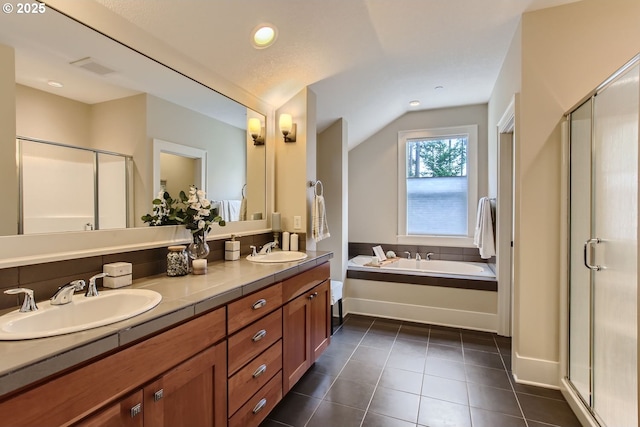 bathroom with vanity, tile patterned floors, separate shower and tub, and lofted ceiling