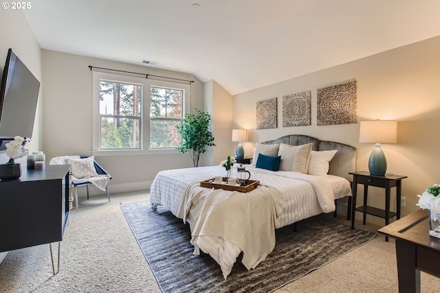 bedroom with lofted ceiling, carpet, and baseboards