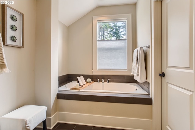 bathroom featuring a bath, tile patterned flooring, and vaulted ceiling