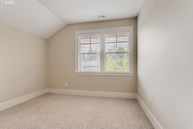 additional living space featuring visible vents, baseboards, and lofted ceiling