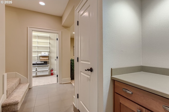 bathroom with recessed lighting and a textured wall