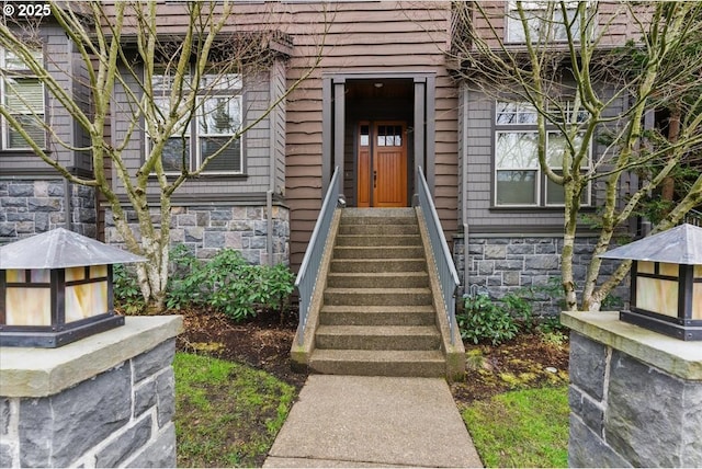 property entrance with stone siding