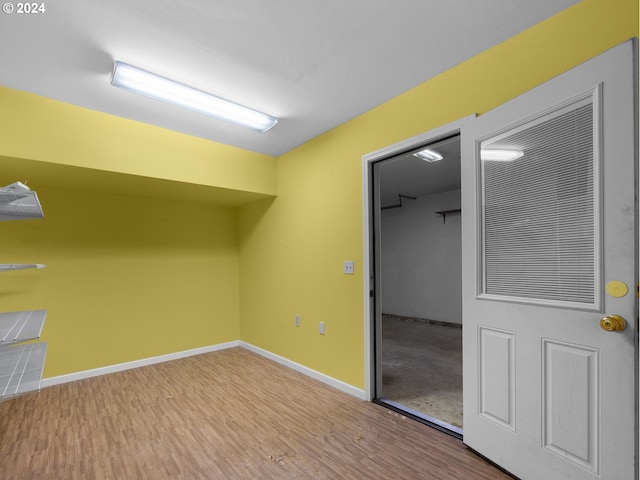 spare room featuring wood finished floors and baseboards