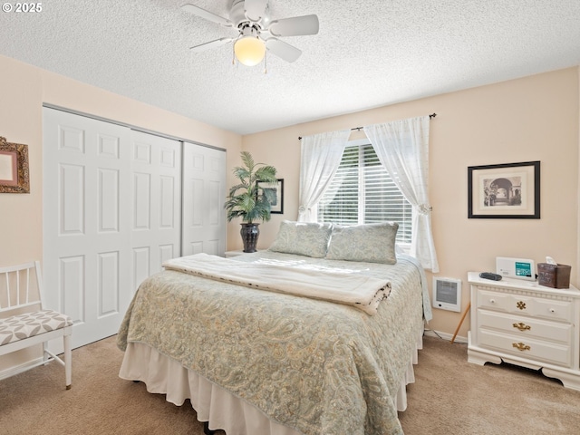 bedroom featuring a ceiling fan, baseboards, a closet, a textured ceiling, and light colored carpet