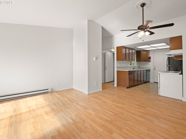 unfurnished living room with baseboards, a baseboard radiator, light wood-style flooring, a sink, and ceiling fan