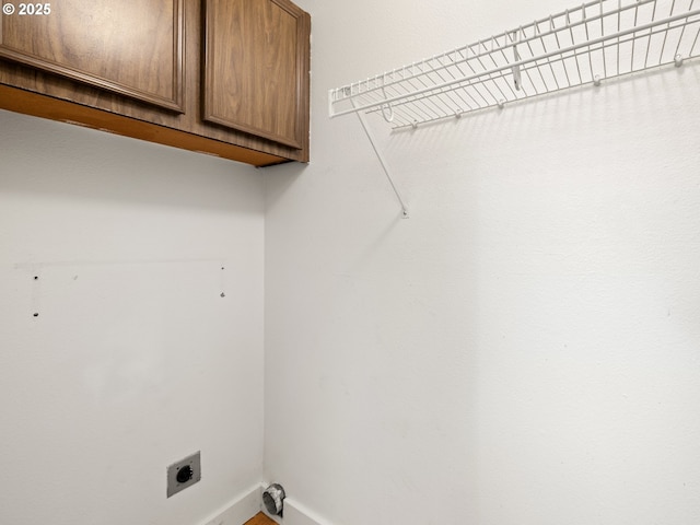 laundry room with cabinet space and hookup for an electric dryer