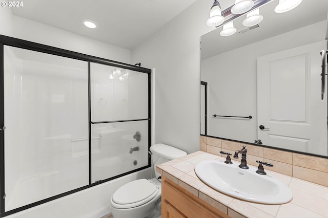 full bathroom featuring visible vents, toilet, decorative backsplash, combined bath / shower with glass door, and vanity