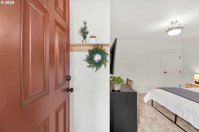 bedroom featuring light carpet