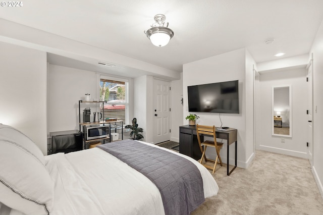 bedroom featuring baseboards, visible vents, and light colored carpet