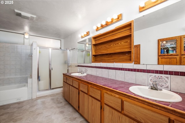 full bath featuring double vanity, a stall shower, visible vents, and a sink