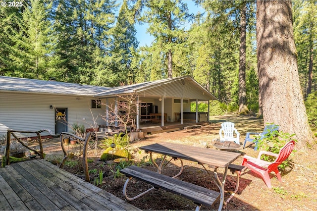 back of property with an outdoor fire pit