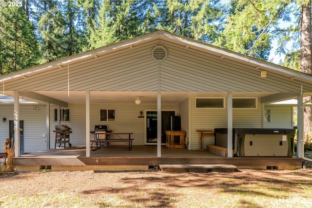 rear view of property featuring a wooden deck