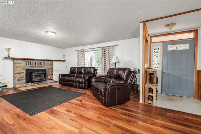 living room with a textured ceiling and wood finished floors