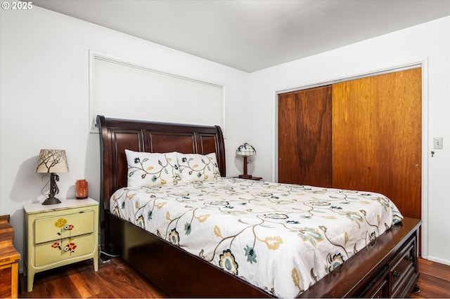 bedroom featuring a closet and dark wood finished floors