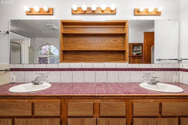 full bathroom featuring double vanity, tasteful backsplash, and a sink