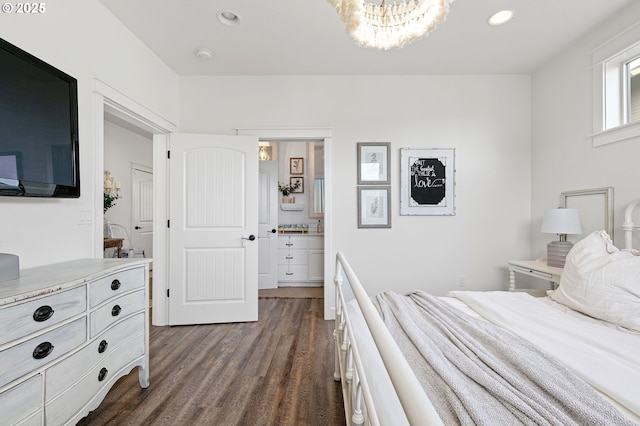 bedroom with a chandelier, dark hardwood / wood-style flooring, and ensuite bath