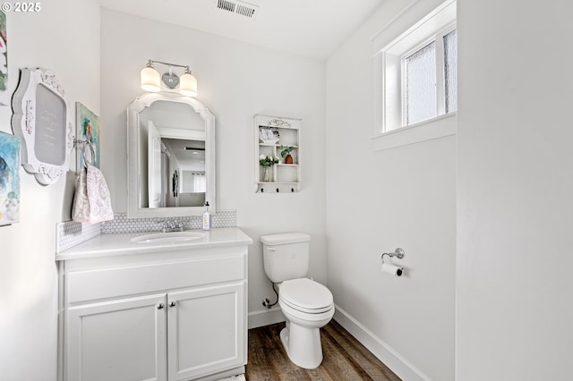 bathroom with vanity, hardwood / wood-style floors, and toilet