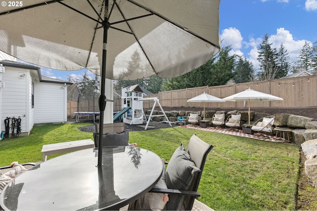 view of patio featuring a playground and a trampoline