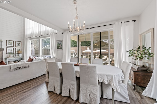 dining space with an inviting chandelier and hardwood / wood-style flooring