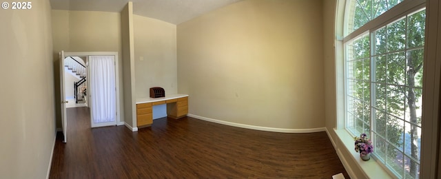 interior space featuring built in desk and dark wood-type flooring