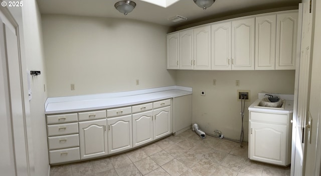 washroom featuring gas dryer hookup, sink, cabinets, washer hookup, and electric dryer hookup